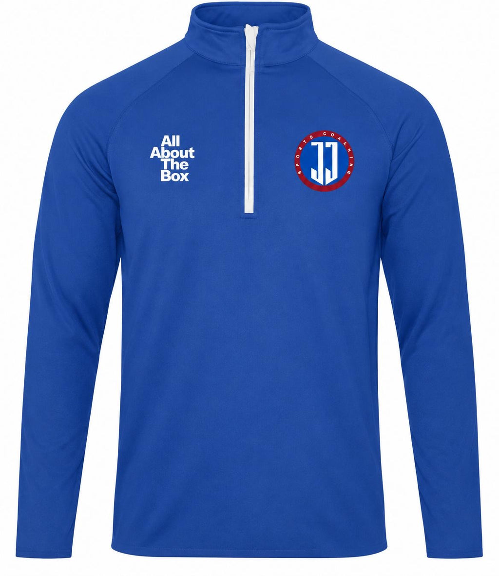 A royal blue long-sleeve quarter-zip pullover with a white zipper, featuring the white text 'All About The Box' on the right chest and a circular red, white, and blue 'JJ' logo on the left chest.